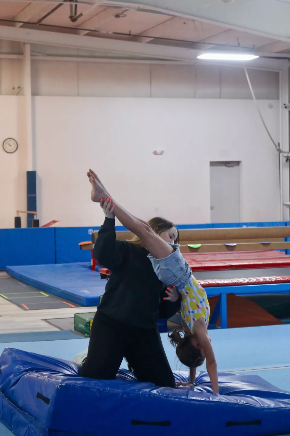 A gymnast building skills during class