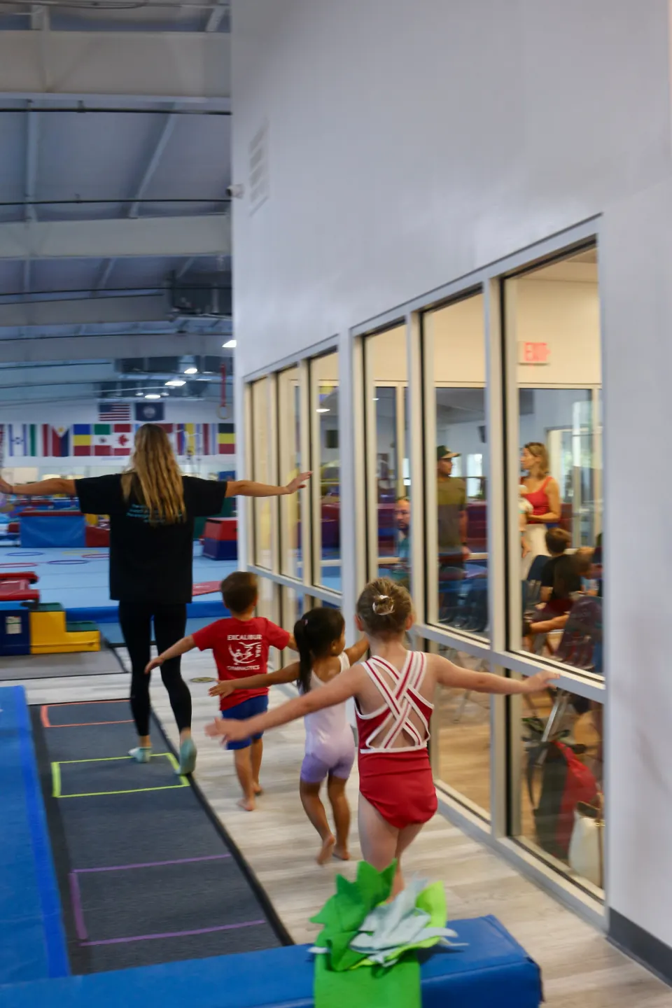 A parent and child taking part in gymnastics class